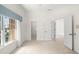 Bright bedroom with large windows, neutral carpet, and multiple doorways, creates an open feel at 8 Dominica Dr, Englewood, FL 34223