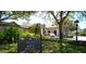 Welcoming clubhouse entrance with lush landscaping and porte cochere at Boca Royale at 8 Dominica Dr, Englewood, FL 34223