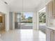 Dining area with tile floors and view of screened pool area at 8 Dominica Dr, Englewood, FL 34223