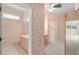 Hallway view to bathroom with floral wallpaper and multiple entrances, enhancing flow at 8 Dominica Dr, Englewood, FL 34223