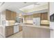 Bright kitchen features light-colored cabinets, white appliances, and tile flooring at 8 Dominica Dr, Englewood, FL 34223