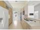 Clean kitchen with light wood cabinets, light countertops and tile floors at 8 Dominica Dr, Englewood, FL 34223