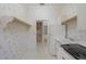 Bright laundry room boasts modern appliances, tile flooring, and floral wallpaper at 8 Dominica Dr, Englewood, FL 34223
