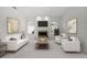 Living room showcasing a fireplace, paintings, and stylish furniture arrangement at 8 Dominica Dr, Englewood, FL 34223