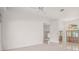 Expansive living room features detailed trim work, neutral paint, and tile flooring at 8 Dominica Dr, Englewood, FL 34223
