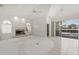 Bright living room boasts fireplace, natural light, and view of the pool area at 8 Dominica Dr, Englewood, FL 34223