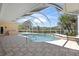 Screened pool with tiled deck offers sunny spot to relax at 8 Dominica Dr, Englewood, FL 34223