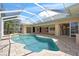Inviting screened-in pool with stone patio offers a private outdoor oasis with access to the home at 8 Dominica Dr, Englewood, FL 34223