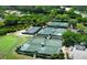 Aerial view of multiple well-maintained tennis courts surrounded by green landscaping at 8 Dominica Dr, Englewood, FL 34223