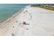 Expansive beachfront aerial view with lifeguard station, clear turquoise water, and a sandy beach at 924 Indian Beach Dr, Sarasota, FL 34234