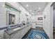Bright bathroom featuring double sinks, modern fixtures, a glass-enclosed shower, and a soaking tub at 924 Indian Beach Dr, Sarasota, FL 34234