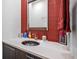 Bathroom featuring a modern sink and vanity with stylish red tile backsplash at 924 Indian Beach Dr, Sarasota, FL 34234