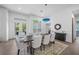 Bright dining room featuring a modern table with seating for six and stylish blue pendant lighting fixture at 924 Indian Beach Dr, Sarasota, FL 34234