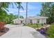 Stunning home featuring a circular driveway, a well manicured lawn and vibrant flowering shrubs at 924 Indian Beach Dr, Sarasota, FL 34234
