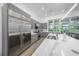 Modern kitchen featuring stainless appliances, stone countertops, grey cabinetry, and lots of natural light at 924 Indian Beach Dr, Sarasota, FL 34234