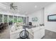 Comfortable living room with plush sofas, glass coffee tables, and sliding glass doors to the backyard at 924 Indian Beach Dr, Sarasota, FL 34234