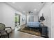 Serene main bedroom with four-poster bed, soft lighting, and sliding glass door to a private patio at 924 Indian Beach Dr, Sarasota, FL 34234