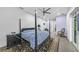 Spacious main bedroom featuring a four-poster bed, ceiling fan, and a door to the walk-in closet at 924 Indian Beach Dr, Sarasota, FL 34234