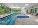 Beautiful indoor pool with an adjacent jacuzzi and serene outdoor views at 924 Indian Beach Dr, Sarasota, FL 34234