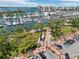 Aerial view showcasing a waterfront harbor filled with boats against the beautiful cityscape backdrop at 101 S Gulfstream Ave # 6C, Sarasota, FL 34236
