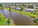 Waterfront homes boast screened lanais along a canal, offering serene outdoor living and neighborhood charm at 104 Hourglass Dr, Venice, FL 34293