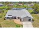 Scenic aerial view of a home with a lakefront setting, lush landscaping, and a well-maintained exterior at 104 Hourglass Dr, Venice, FL 34293