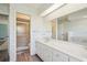 The bathroom features a double sink vanity and a walk in shower at 104 Hourglass Dr, Venice, FL 34293