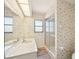 Bathroom with seashell wallpaper, shower, and double sink at 104 Hourglass Dr, Venice, FL 34293