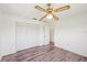 Bright bedroom features hardwood floors, a ceiling fan, and a closet at 104 Hourglass Dr, Venice, FL 34293