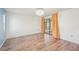 Bedroom with a hardwood floor and a view of a patio through the sliding glass door at 104 Hourglass Dr, Venice, FL 34293
