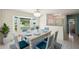 Bright dining room featuring a bay window, a table set for six, and a stylish chandelier at 104 Hourglass Dr, Venice, FL 34293