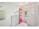 Welcoming foyer with bright red front door, tile flooring, and decorative lighting fixture at 104 Hourglass Dr, Venice, FL 34293