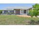Charming single-story home featuring a well-maintained lawn, colorful flower beds, and a brick-paved walkway to the front door at 104 Hourglass Dr, Venice, FL 34293