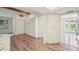 Hardwood flooring in a brightly-lit living area with white storage and cabinets at 104 Hourglass Dr, Venice, FL 34293