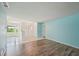 Cozy living room with wood flooring, modern color accents, and sliding glass doors at 104 Hourglass Dr, Venice, FL 34293