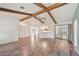 Open living space with wood floors, exposed beams, and views to the kitchen, sunroom, and hallways at 104 Hourglass Dr, Venice, FL 34293