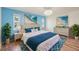 Bright main bedroom suite with blue decor and beach-themed wall art at 104 Hourglass Dr, Venice, FL 34293