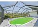Screened pool with view of lake and back yard at 104 Hourglass Dr, Venice, FL 34293