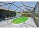 Enclosed screened-in pool featuring a spacious deck area, lounge chairs, and a clear blue sky above at 104 Hourglass Dr, Venice, FL 34293