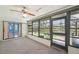 The carpeted sunroom offers a view of the pool and sliding glass doors at 104 Hourglass Dr, Venice, FL 34293