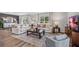Bright and airy living room with hardwood floors, neutral decor, and lots of natural light at 10722 Hidden Banks Gln, Parrish, FL 34219