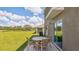 Outdoor patio area features a table with seating and a sliding glass door to the home at 10722 Hidden Banks Gln, Parrish, FL 34219