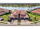Gorgeous aerial shot of a beautiful house with lovely landscaping situated near a lake and golf course at 10820 Tarflower Dr # 202, Venice, FL 34293