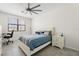 Bright bedroom with a large window, ceiling fan, and computer desk, perfect for relaxing or working at 10820 Tarflower Dr # 202, Venice, FL 34293
