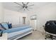 This bedroom features a ceiling fan, a TV, computer desk, and an ensuite bathroom and walk-in closet at 10820 Tarflower Dr # 202, Venice, FL 34293