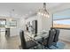 Bright dining area adjacent to a modern kitchen, featuring a glass table and comfortable seating at 10820 Tarflower Dr # 202, Venice, FL 34293