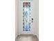 Elegant white door with decorative leaded glass, hardware and tile flooring at 10820 Tarflower Dr # 202, Venice, FL 34293