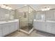 Ensuite bathroom featuring a large glass shower with a bench seat, and double sinks at 10820 Tarflower Dr # 202, Venice, FL 34293