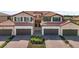 Inviting front exterior featuring well-manicured landscaping and a charming facade with a tile roof at 10820 Tarflower Dr # 202, Venice, FL 34293