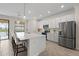 Contemporary kitchen featuring stainless steel appliances, a large island with seating, and bright lighting at 10820 Tarflower Dr # 202, Venice, FL 34293